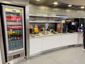 a beverage dispenser and drinks on shelves