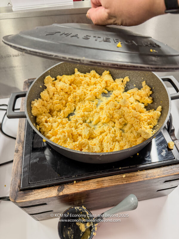 a pan of scrambled eggs on a stove