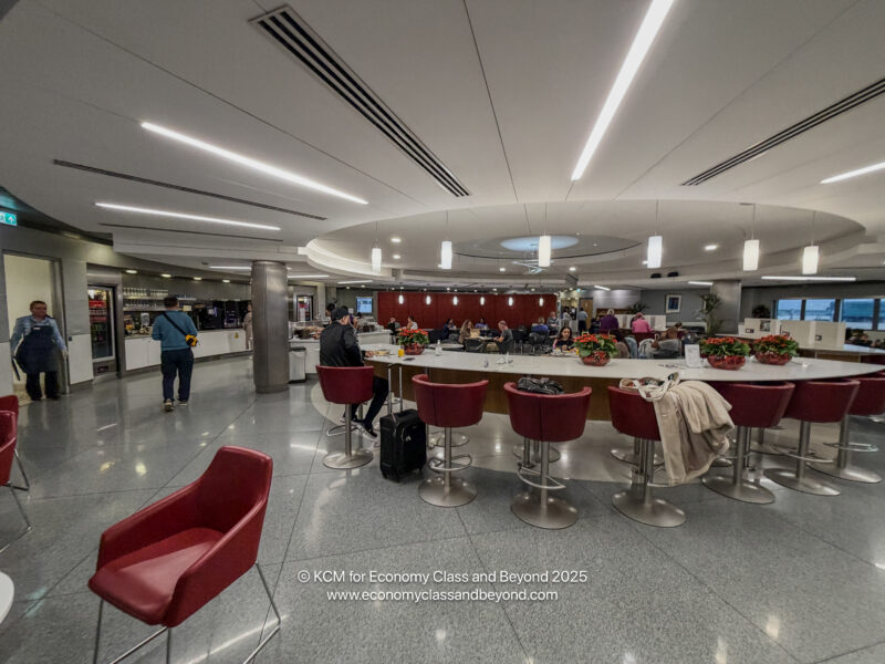 a group of people in a room with tables and chairs