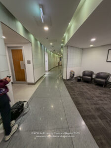 a person with luggage in a hallway