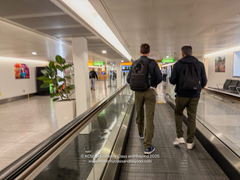 two men walking on an escalator