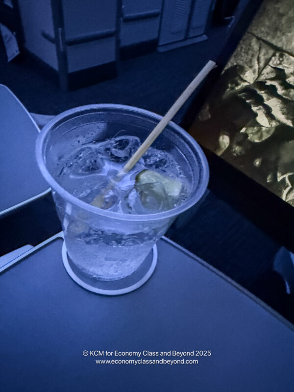 a glass of water with a straw in it