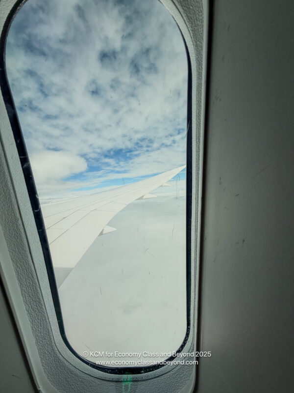 a window with wing of an airplane