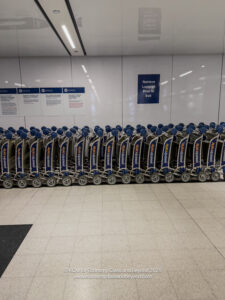 a row of luggage carts in a room