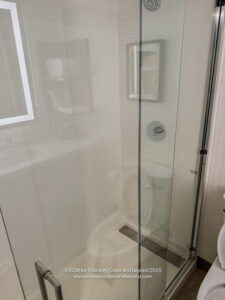 a glass shower door in a bathroom