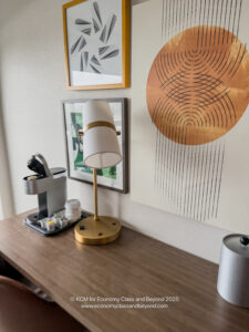 a desk with a lamp and coffee machine
