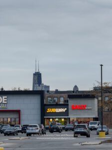 a parking lot with cars parked in front of a building