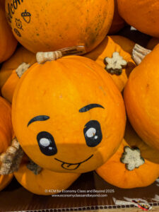 a pile of pumpkins with a face drawn on it
