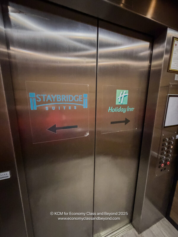 an elevator with a sign and buttons