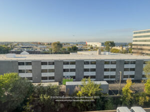 a building with trees and a parking lot