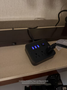 a black power strip with blue leds and a black cord