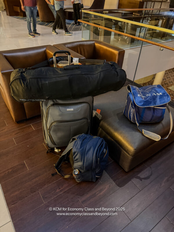 a group of luggage on a leather couch