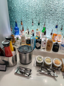a bar with bottles of alcohol and utensils