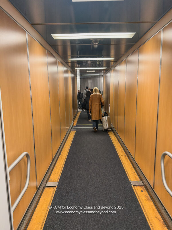 a person with luggage walking down a hallway