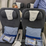 a woman sitting in a plane with two seats