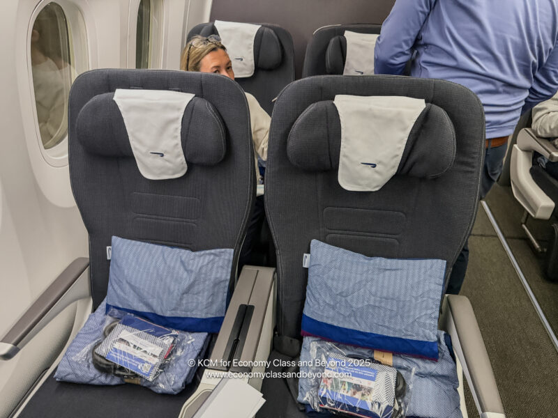 a woman sitting in a plane with two seats