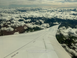 an airplane wing above the clouds