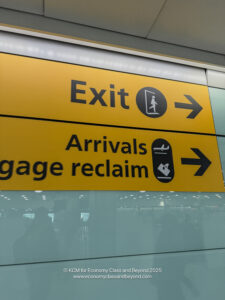 a yellow sign with black text and arrow