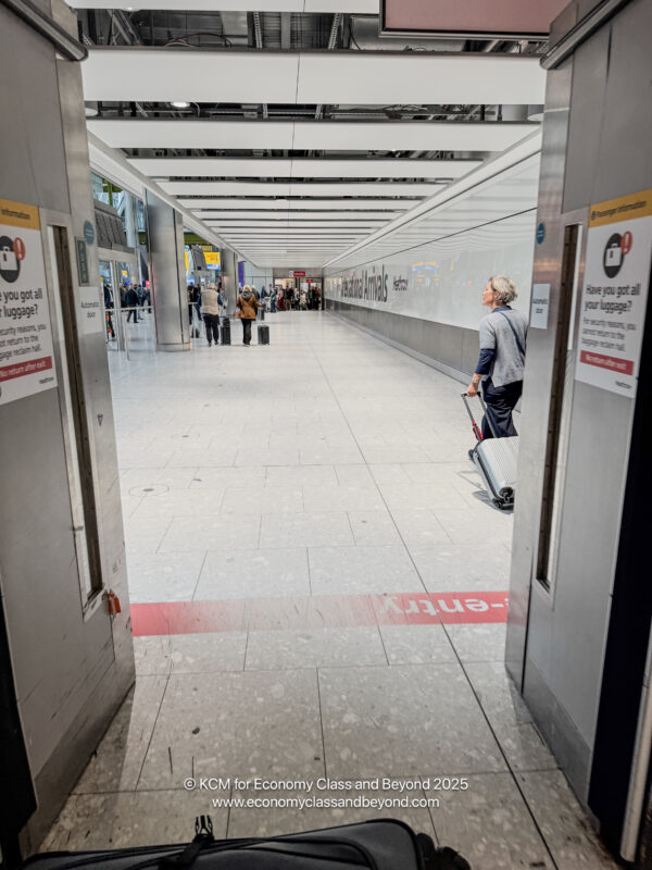 a person with luggage in a hallway