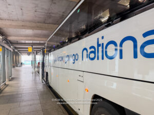 a white bus with blue writing on it