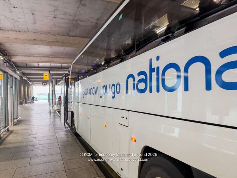 a white bus with blue writing on it