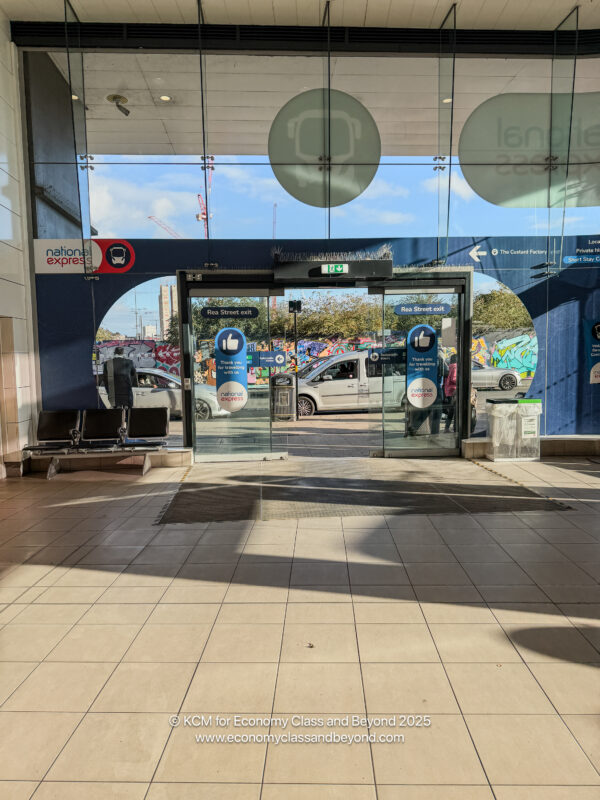 a glass door with a car in the background