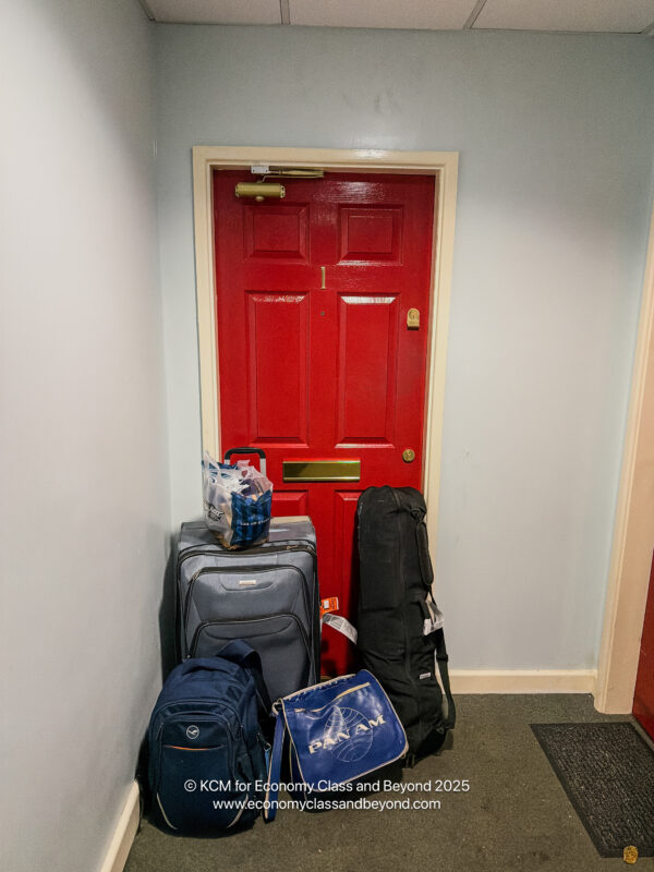 a red door with luggage on it