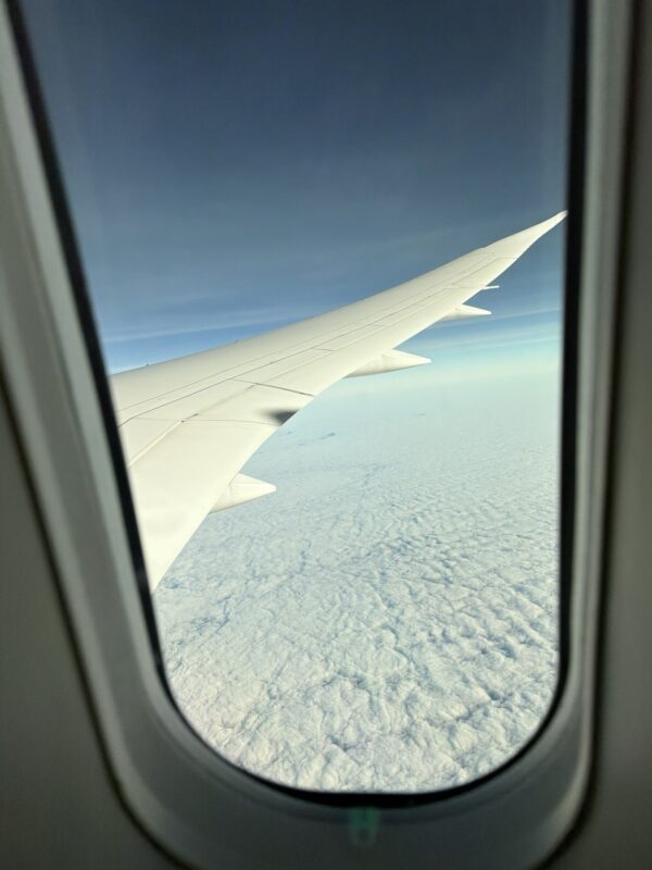 an airplane wing in the sky