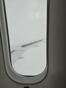 a window with a wing of an airplane