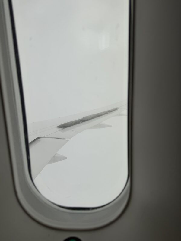 a window with a wing of an airplane