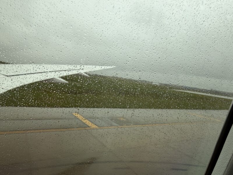 a view of a runway from a window of an airplane