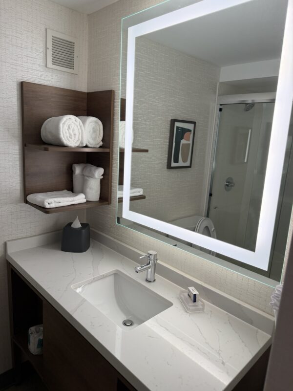 a bathroom with a mirror and a sink