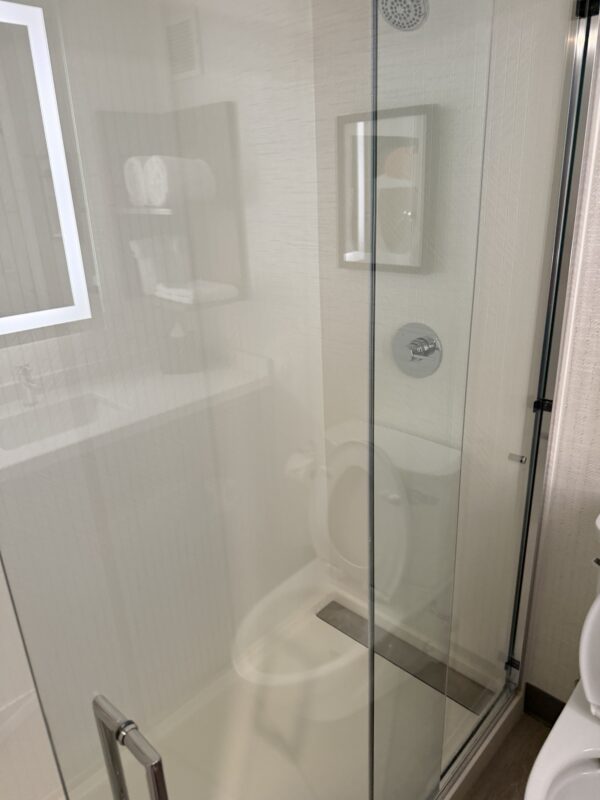 a glass shower door in a bathroom