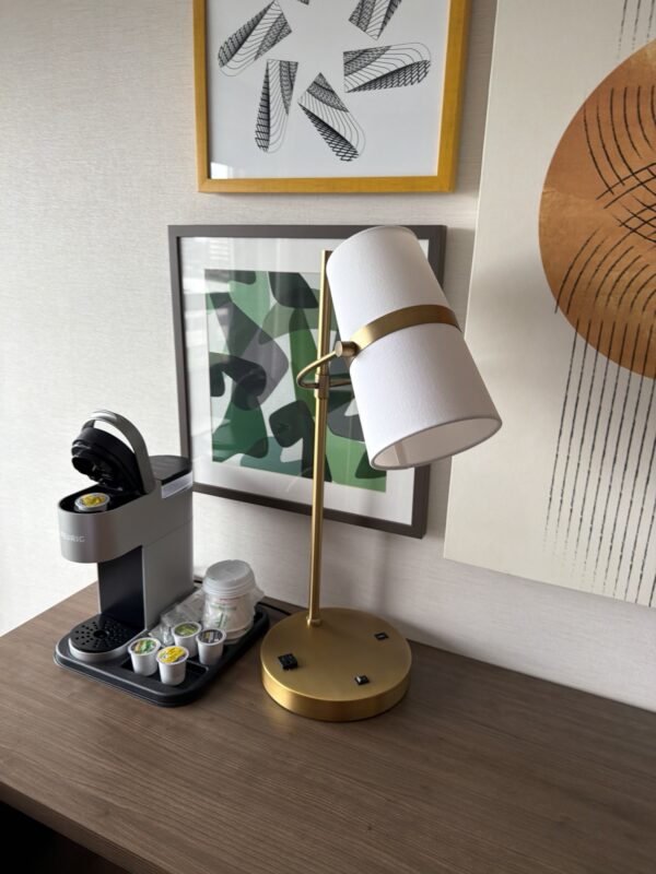 a lamp and coffee machine on a table
