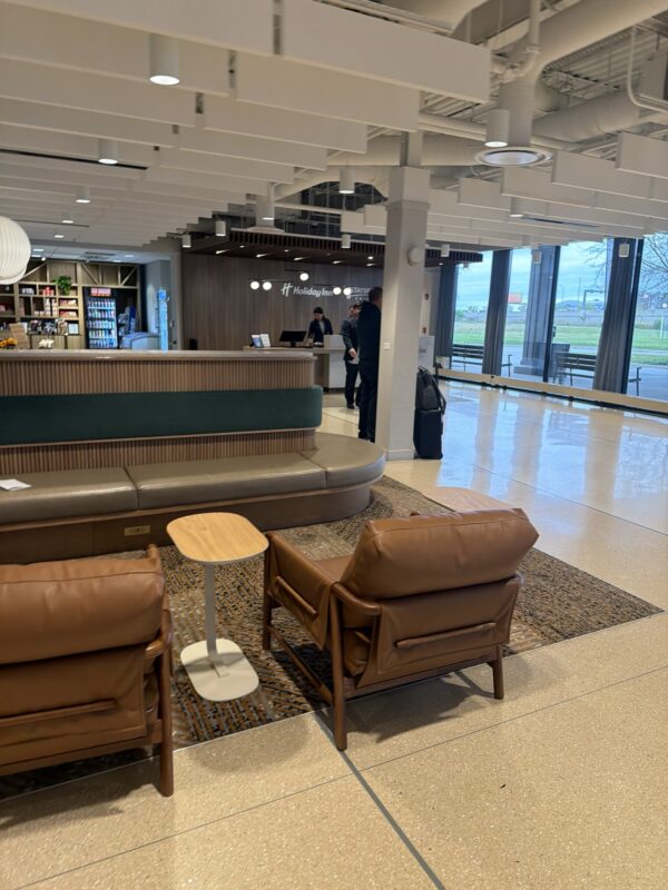 a lobby with a reception desk and chairs