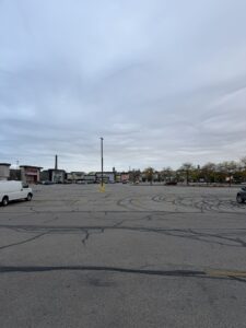 a parking lot with cars and buildings