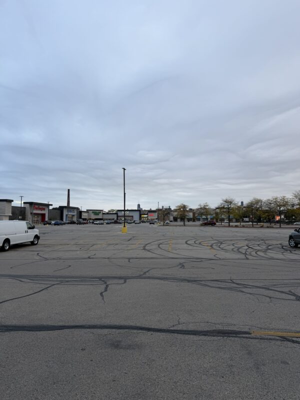 a parking lot with cars and buildings