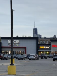 a parking lot with cars in front of a building