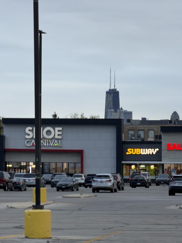 a parking lot with cars in front of a building