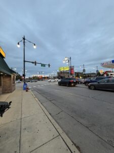 a street with cars and a gas station
