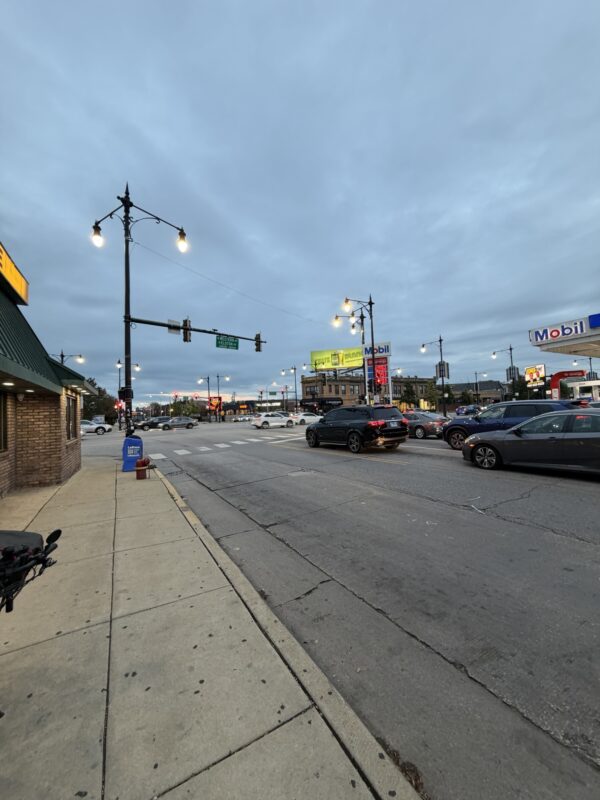 a street with cars and a gas station