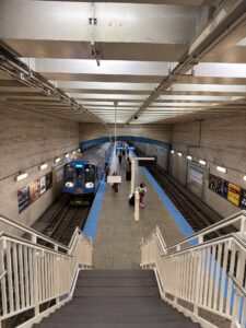 a train station with people walking down stairs