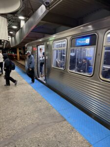 a train with people boarding