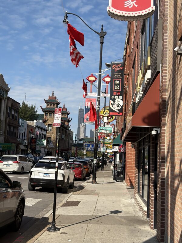 a street with cars and flags
