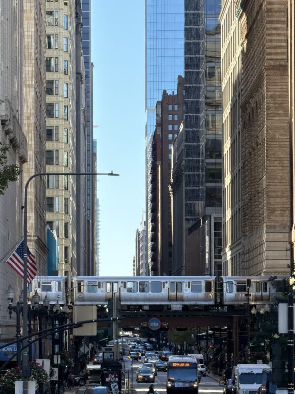 a train on a bridge in a city