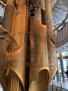 a large gold metal structure with holes