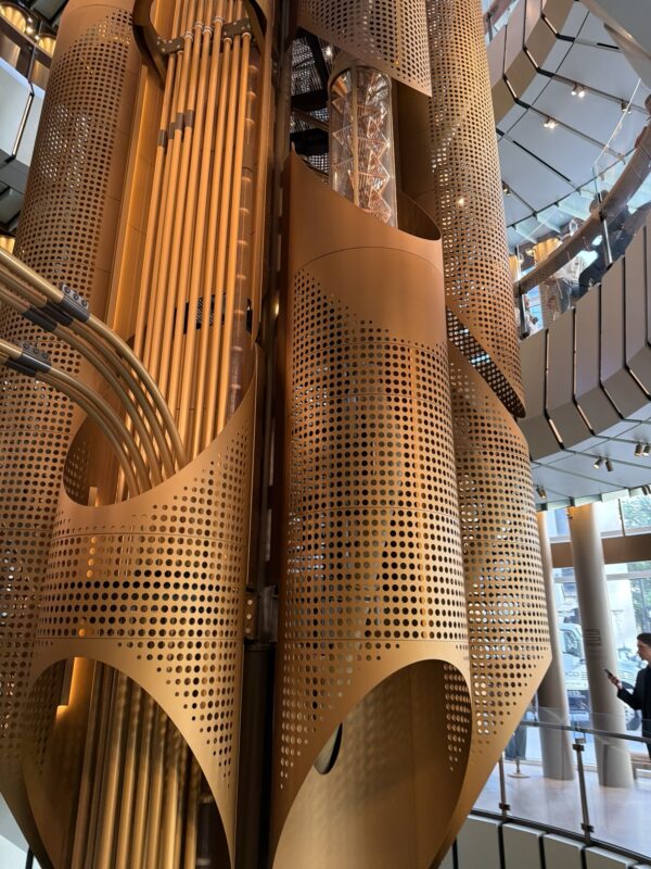 a large gold metal structure with holes