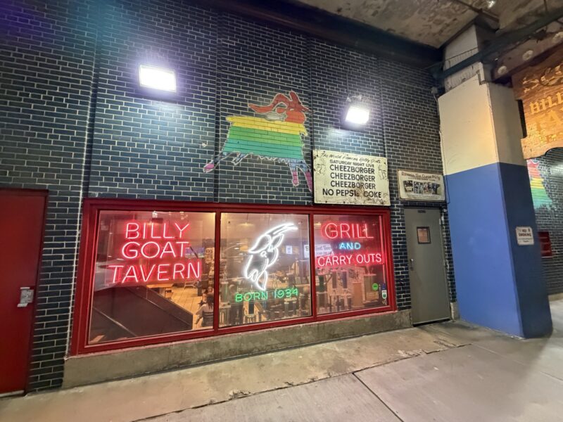 a brick building with neon signs