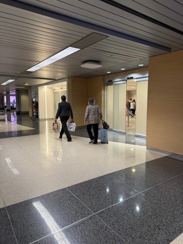 a couple of people walking in a building