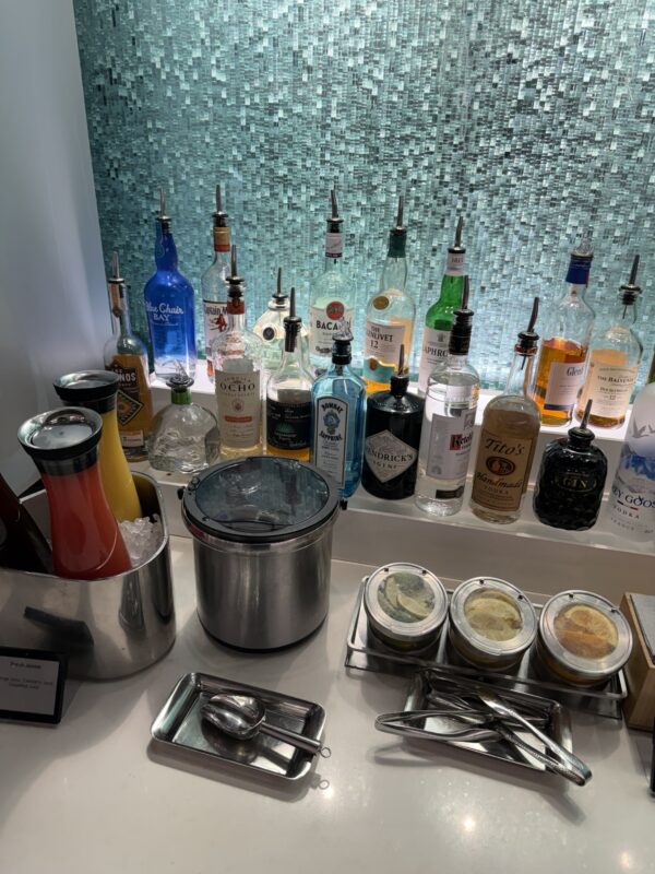 a bar with bottles of alcohol and utensils